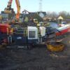 Sandvik mobile jaw crusher at quarry site.